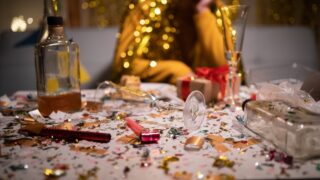 Messy,Table,After,Party,And,Sitting,Blurred,Man,In,Background.